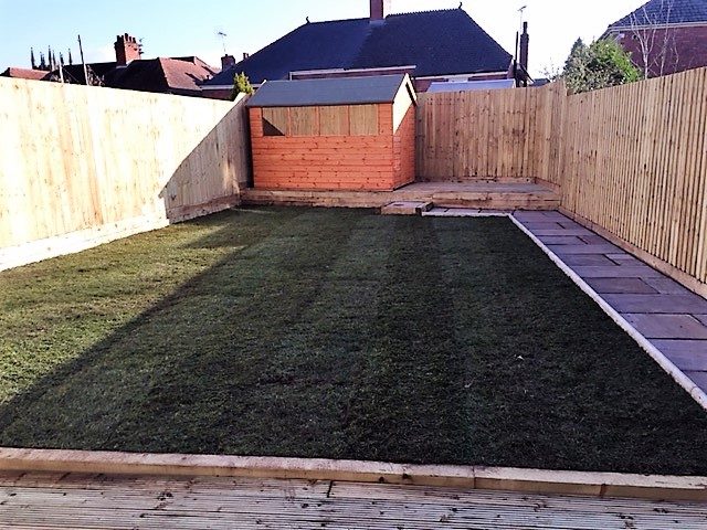 Finished garden with timber decking, turf and new fencing