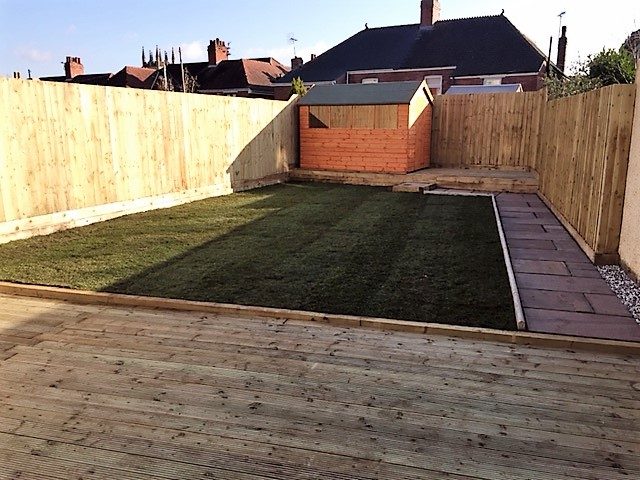 Finished garden with timber decking and rectangular lawn