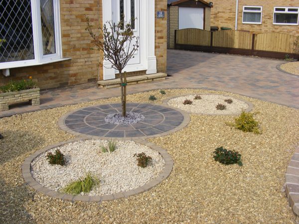 Decorative gravel landscaping with circular brick edging