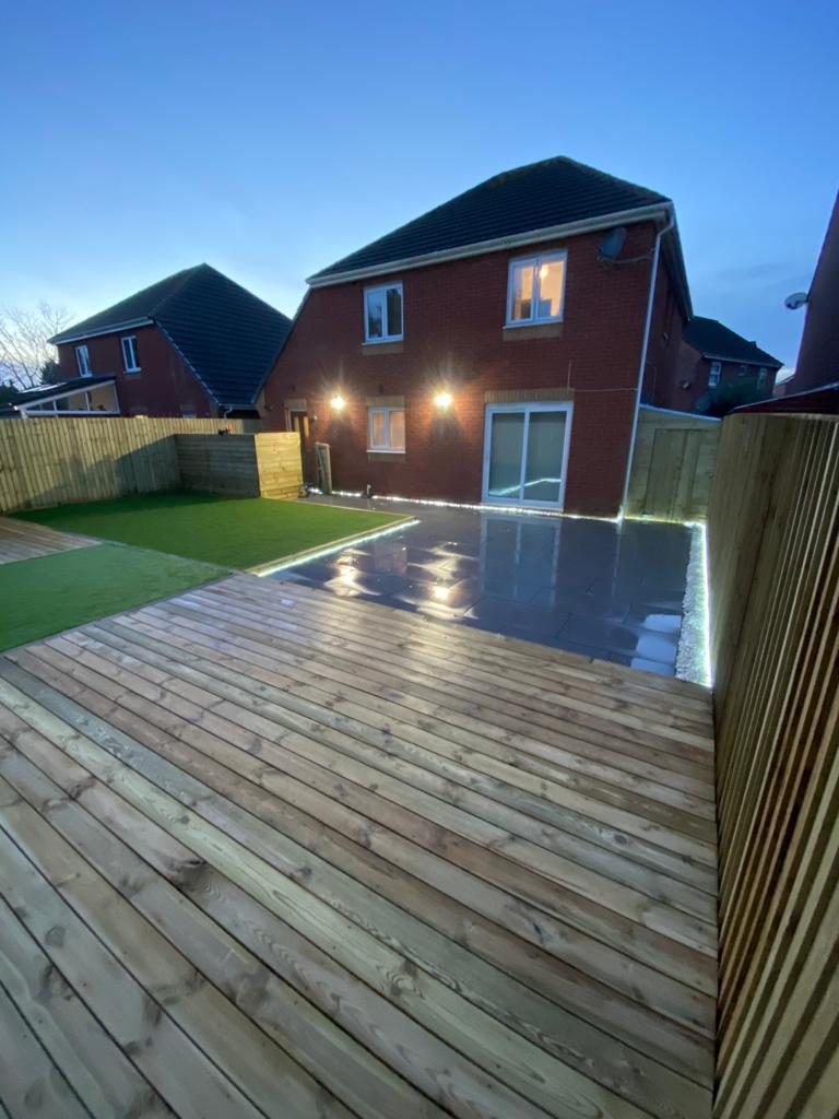 Large timber deck with integrated lighting at dusk