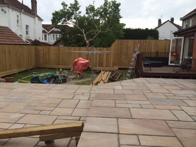 Large paved patio with raised timber edging