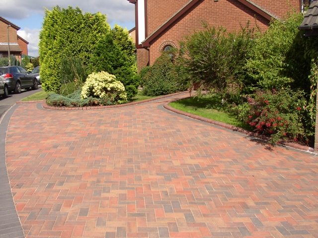 Finished red block paved driveway with curved borders