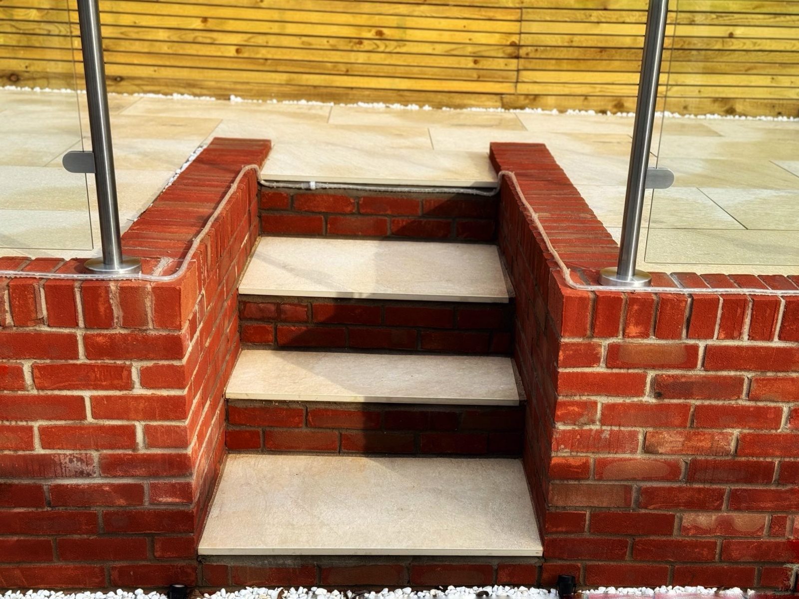 Sandstone steps set between red brick walls