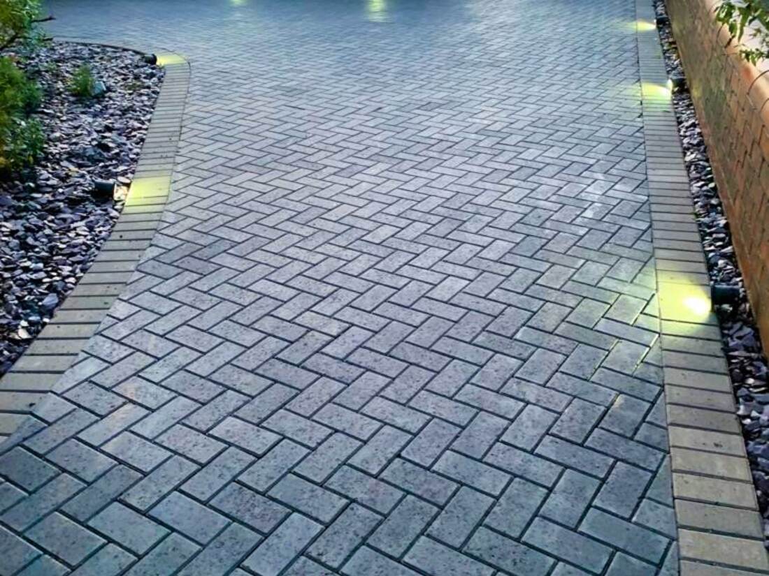 Block paved driveway in dark herringbone with recessed ground lighting